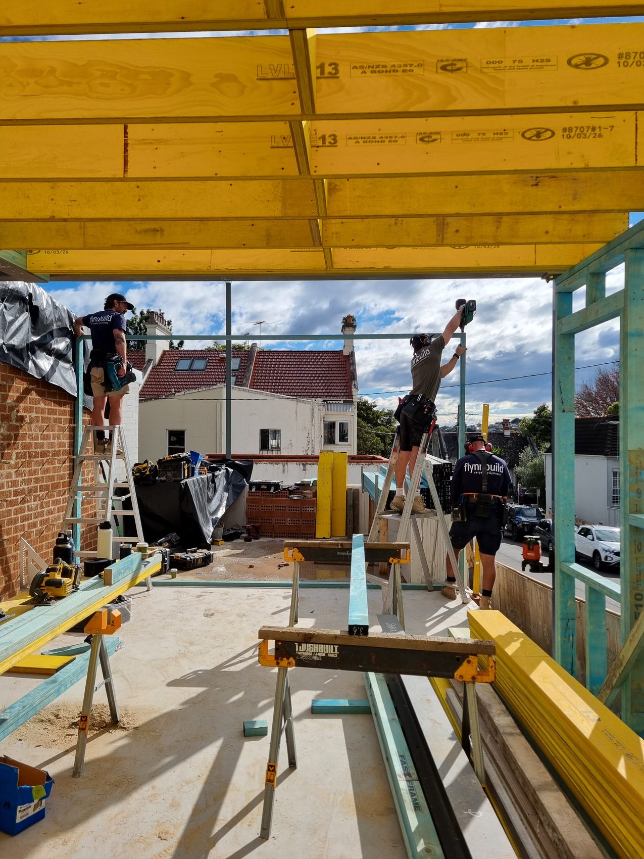 Flynnbuild crew lifting and fixing structural framing on site
