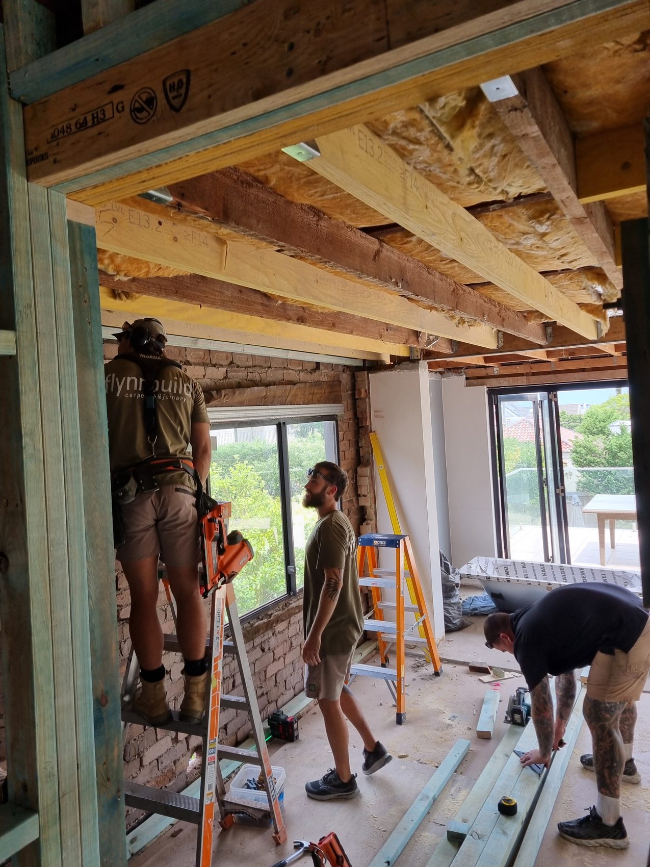 Flynnbuild crew installing timber floor framing on an architectural build